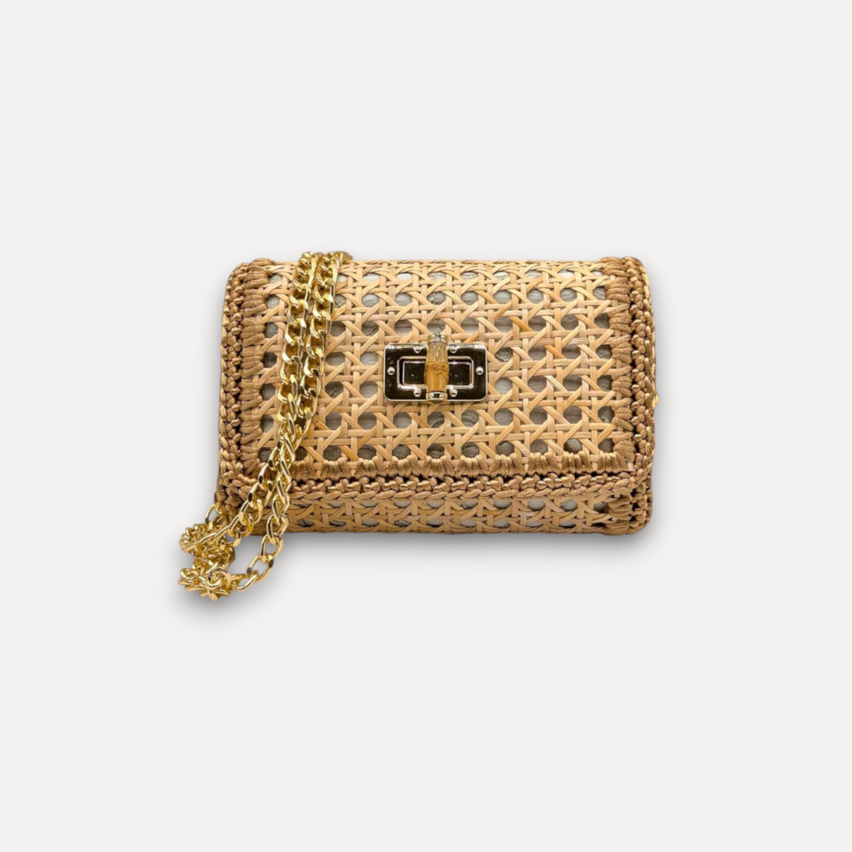Borsa CapriNina Vienna in paglia intrecciata con chiusura dorata e tracolla a catena, design artigianale chic.
