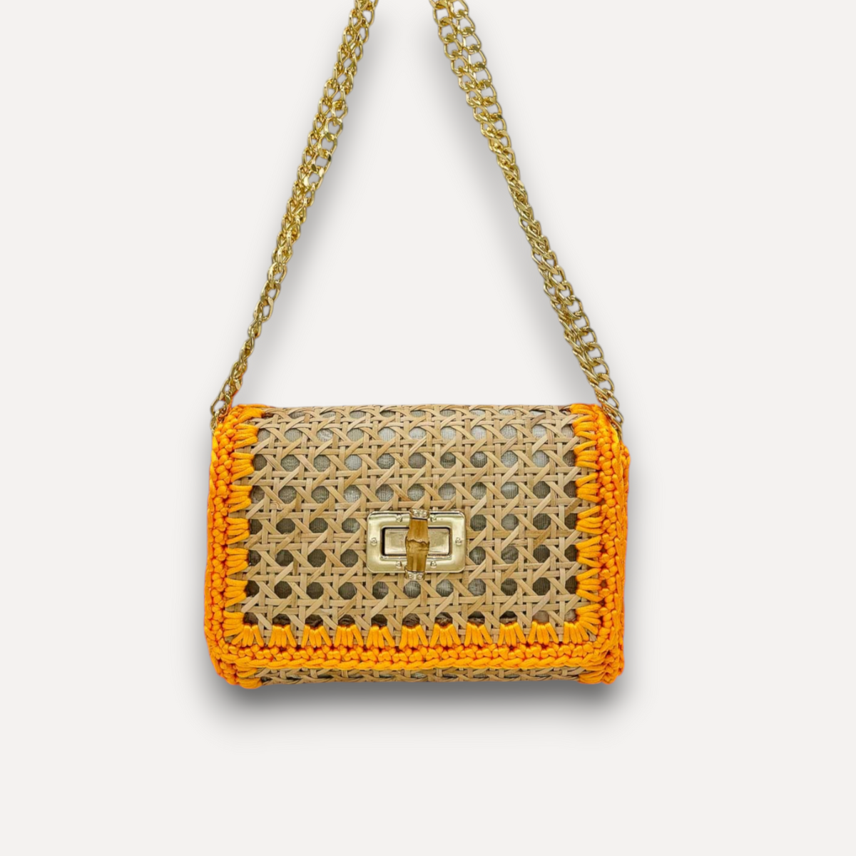 Borsa CapriNina in paglia intrecciata color naturale con bordi in corda arancione e tracolla a catena dorata