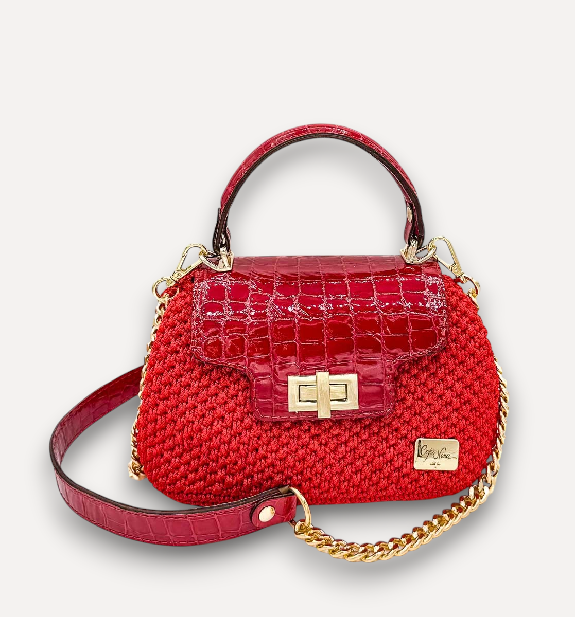 Borsa a mano CapriNina Capriccio rossa in uncinetto con patta in pelle stampa coccodrillo e chiusura a girello oro